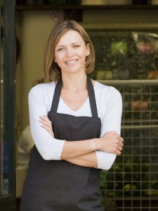 Woman working at flower shop smiling